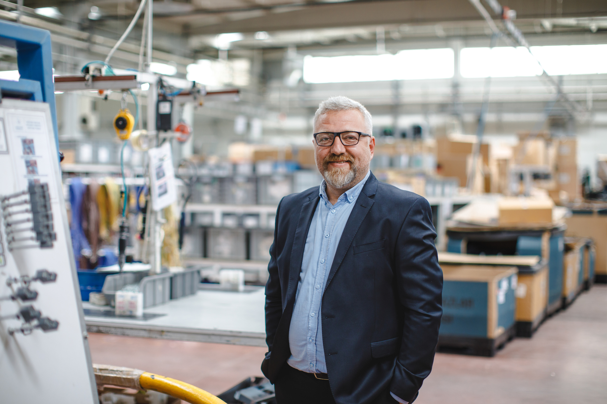 Efficient Factory Management: Portrait of Smiling Senior Manager Businessman or CEO in Industrial Factory Warehouse